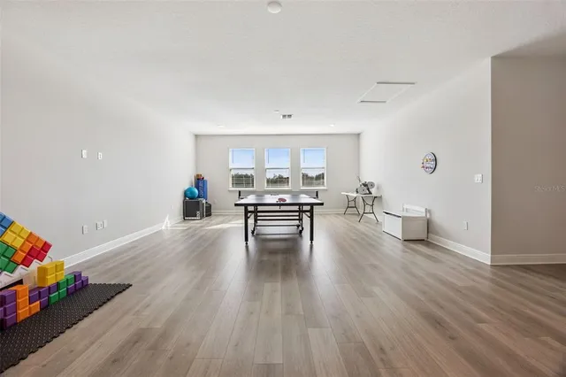 a bathroom with a granite countertop sink toilet mirror and a bathtub
