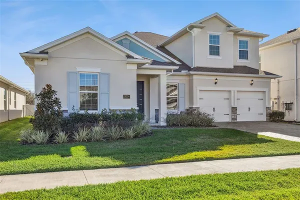 a front view of a house with a yard and garage