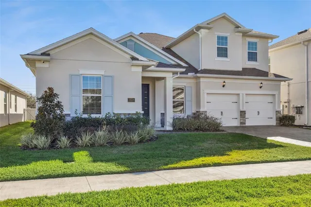 a front view of a house with a yard and garage