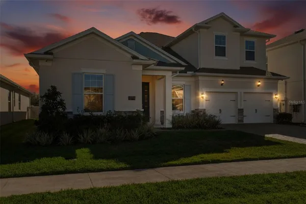 a front view of house with a garden