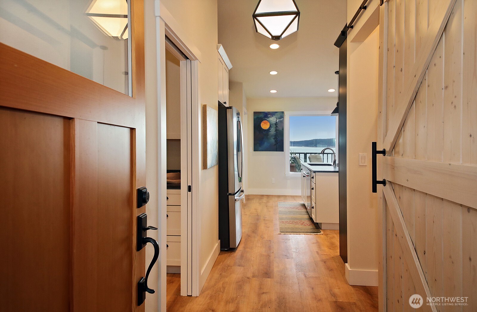 2999 Saratoga Road Langley, WA 98260 - Photo 10 of 40 a view of a hallway with wooden floor and furniture