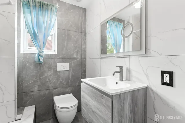 a bathroom with a sink toilet and a mirror