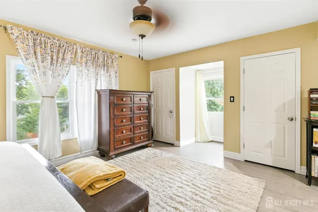 a spacious bedroom with a bed and a cabinets