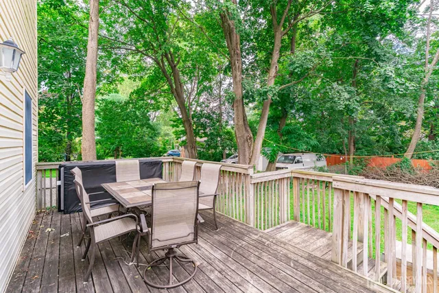 a view of a deck with furniture and trees around