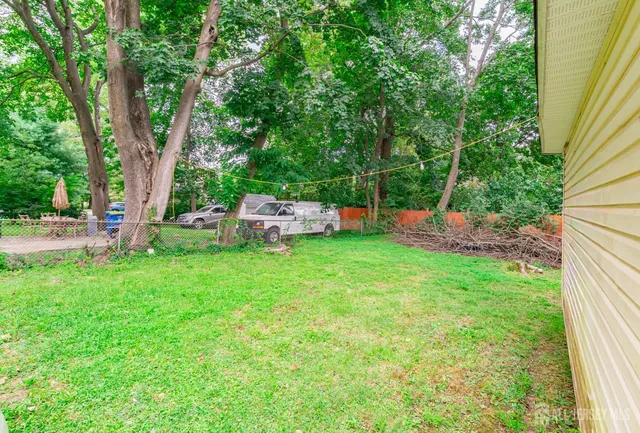 a view of backyard with seating area and green space
