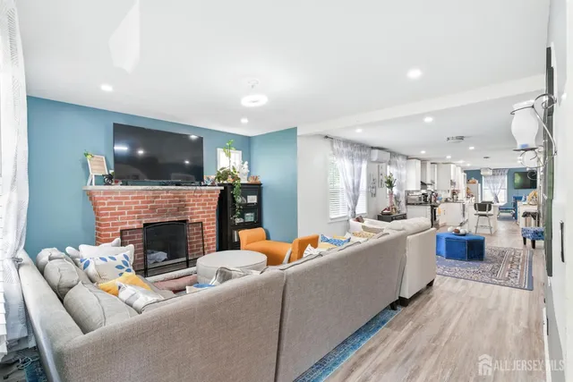 a living room with furniture and a fireplace