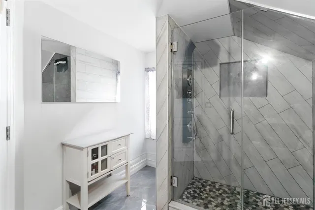 a bathroom with a shower and a sink