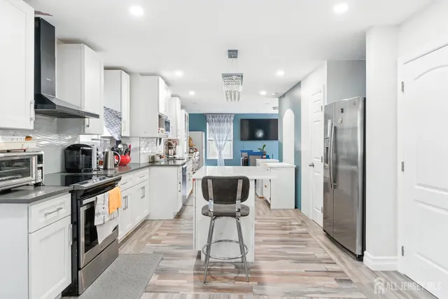 a kitchen with a refrigerator a sink and cabinets