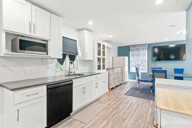 a kitchen with stainless steel appliances granite countertop a sink dishwasher stove and oven