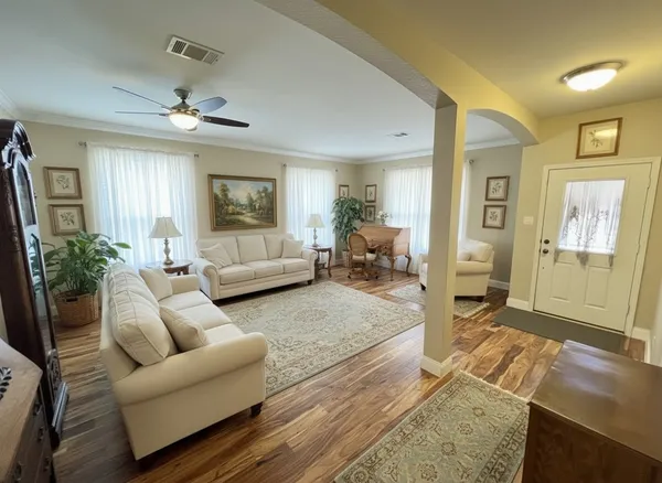 a living room with furniture and a flat screen tv