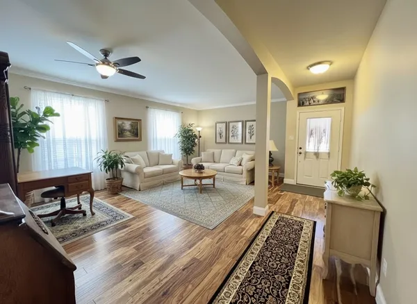 a living room with furniture and a large window