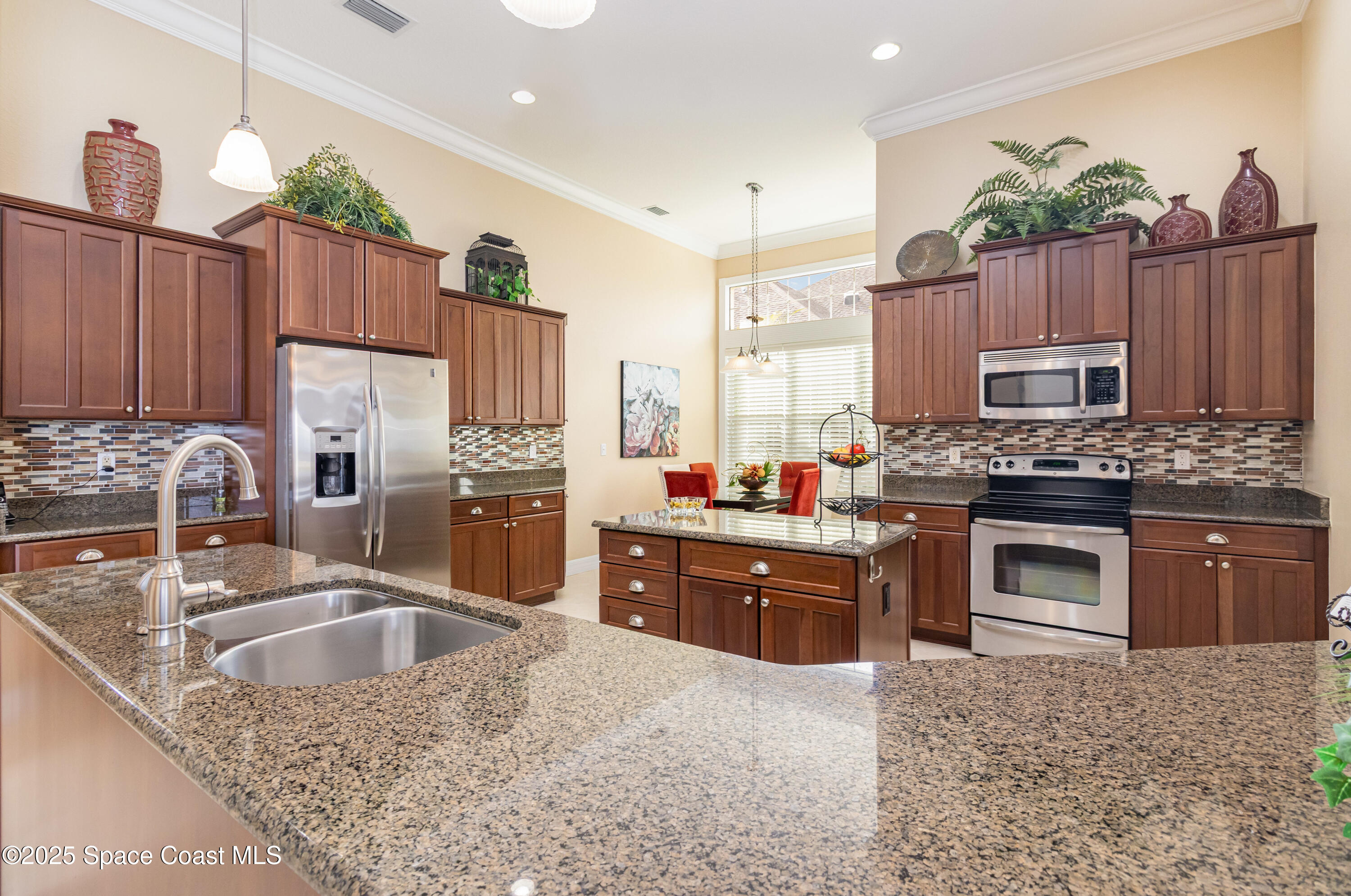 200 Harmony Lane Titusville, FL 32780 - Photo 11 of 28 a kitchen with granite countertop a stove cabinets and refrigerator