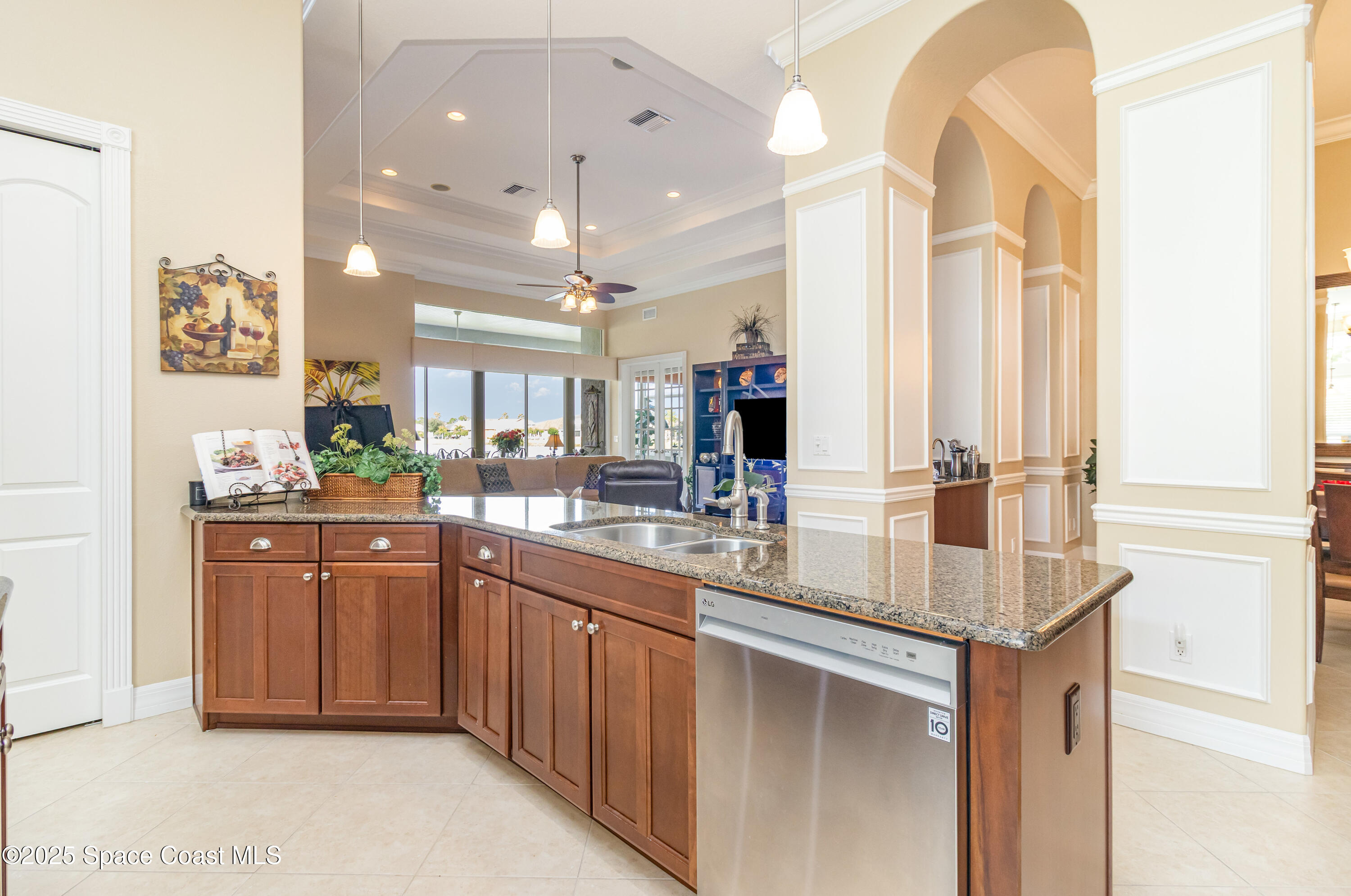 200 Harmony Lane Titusville, FL 32780 - Photo 12 of 28 a kitchen with kitchen island granite countertop a sink and refrigerator
