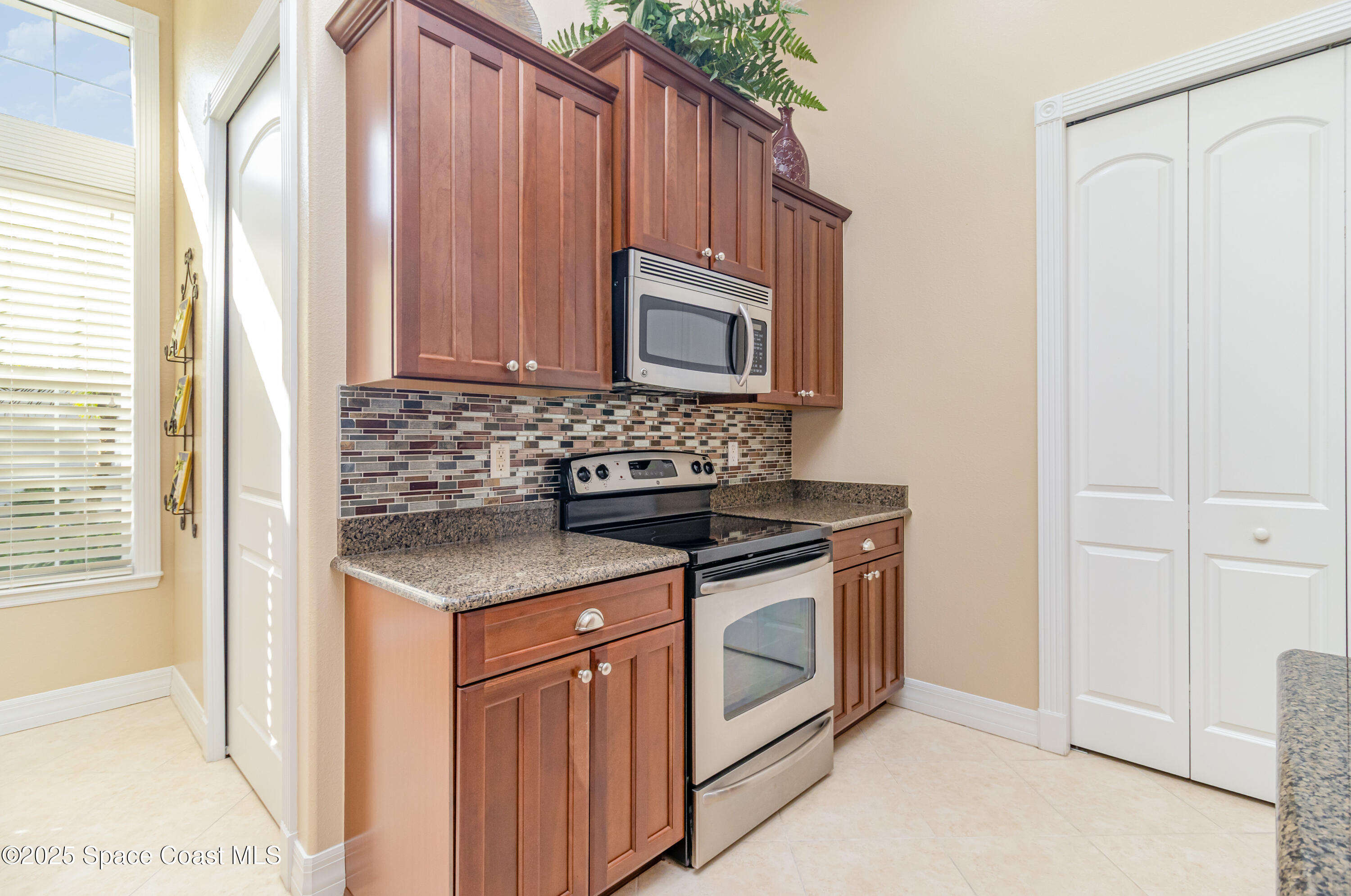 200 Harmony Lane Titusville, FL 32780 - Photo 13 of 28 a stove top oven sitting inside of a kitchen