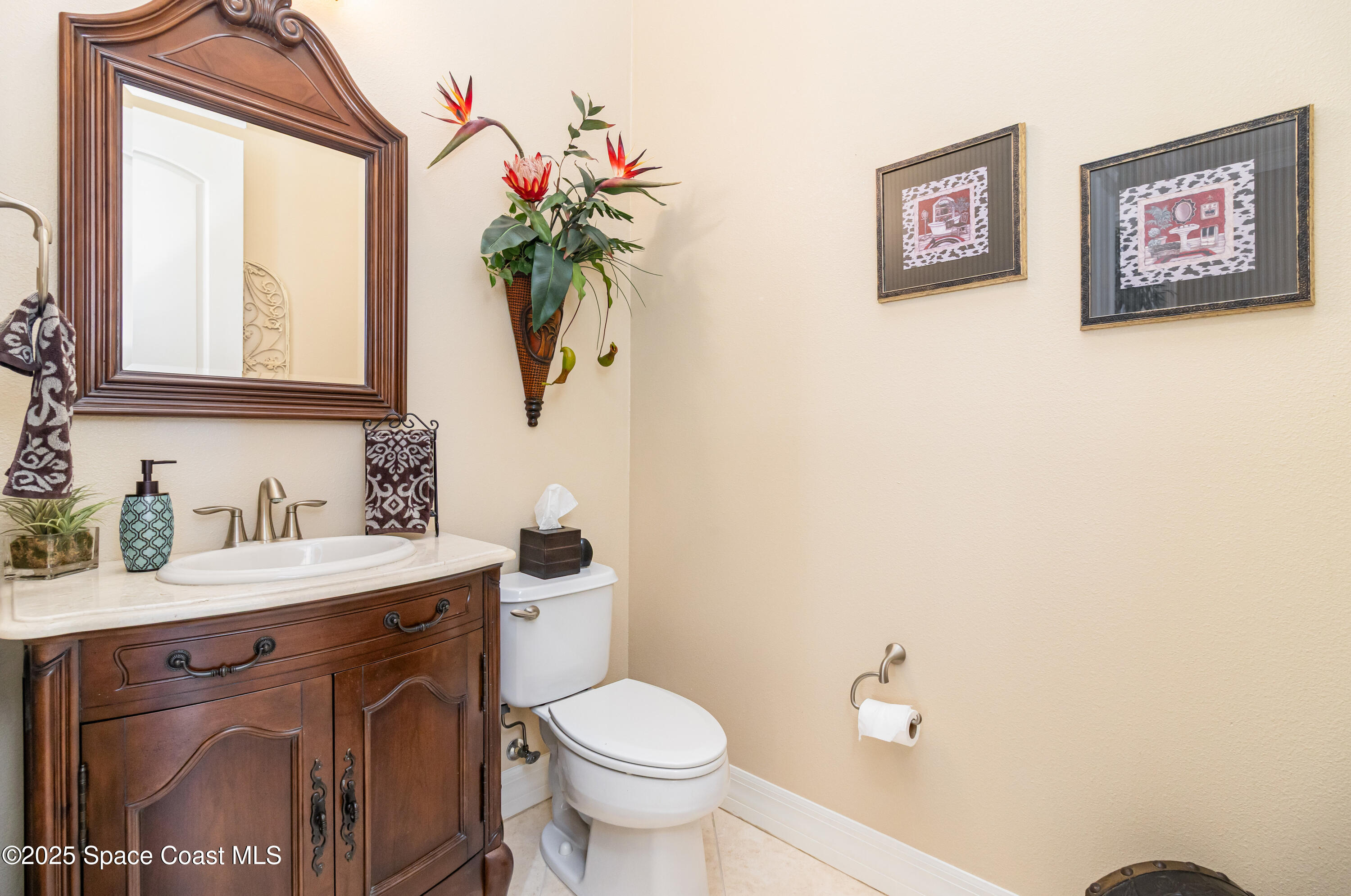 200 Harmony Lane Titusville, FL 32780 - Photo 16 of 28 a bathroom with a toilet sink and mirror