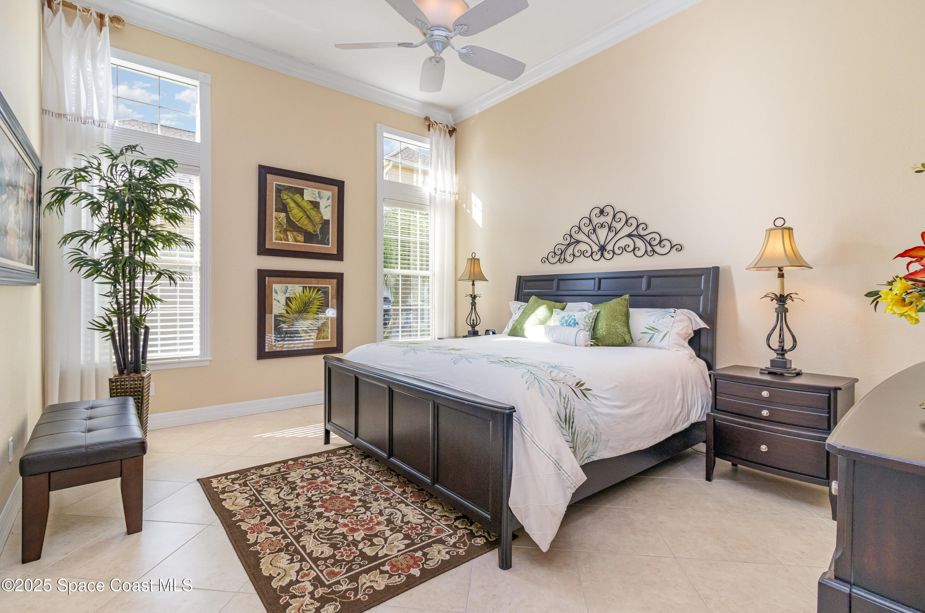 200 Harmony Lane Titusville, FL 32780 - Photo 22 of 28 a bedroom with a large bed and a chandelier