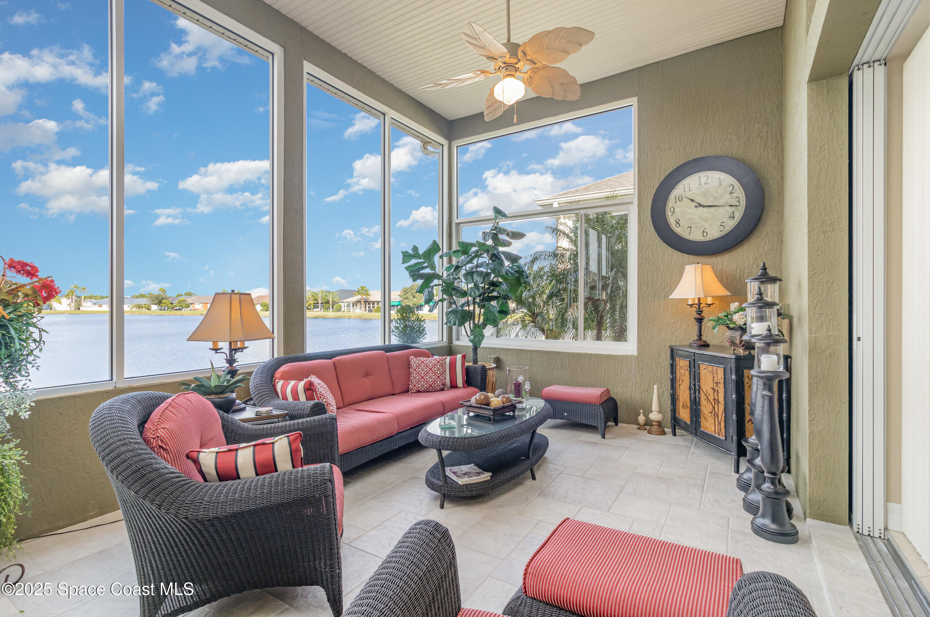 200 Harmony Lane Titusville, FL 32780 - Photo 25 of 28 a living room with furniture a chandelier and a large window