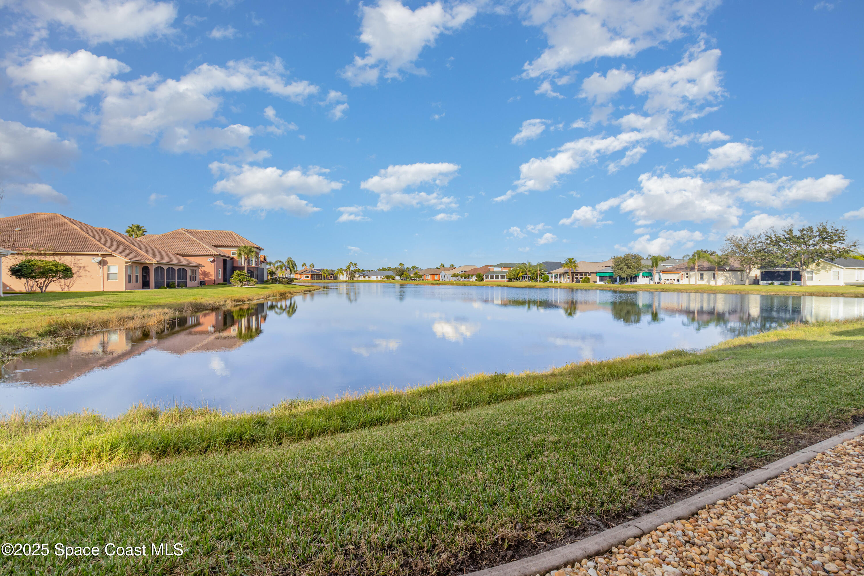 200 Harmony Lane Titusville, FL 32780 - Photo 27 of 28 a view of a lake with houses in the back