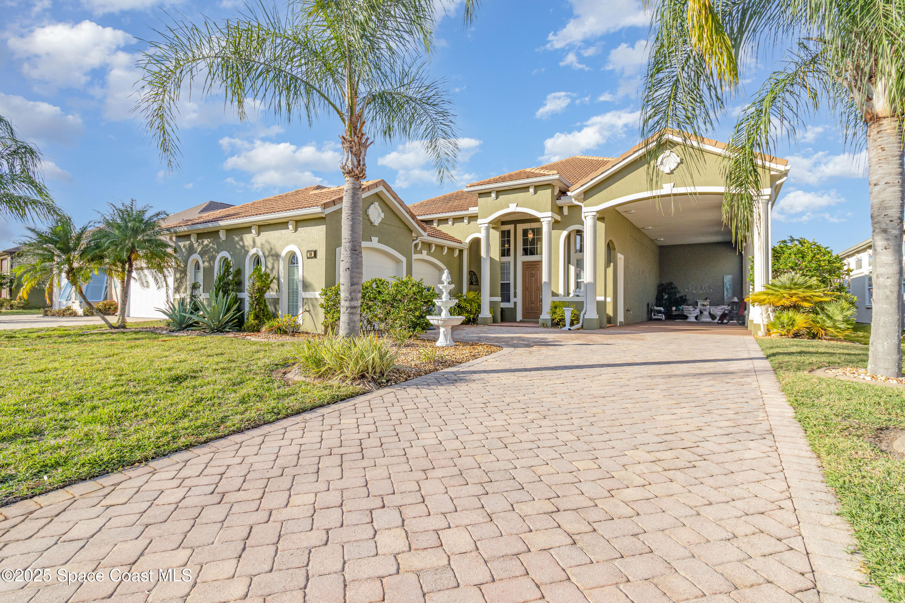 200 Harmony Lane Titusville, FL 32780 - Photo 3 of 28 a front view of a house with garden