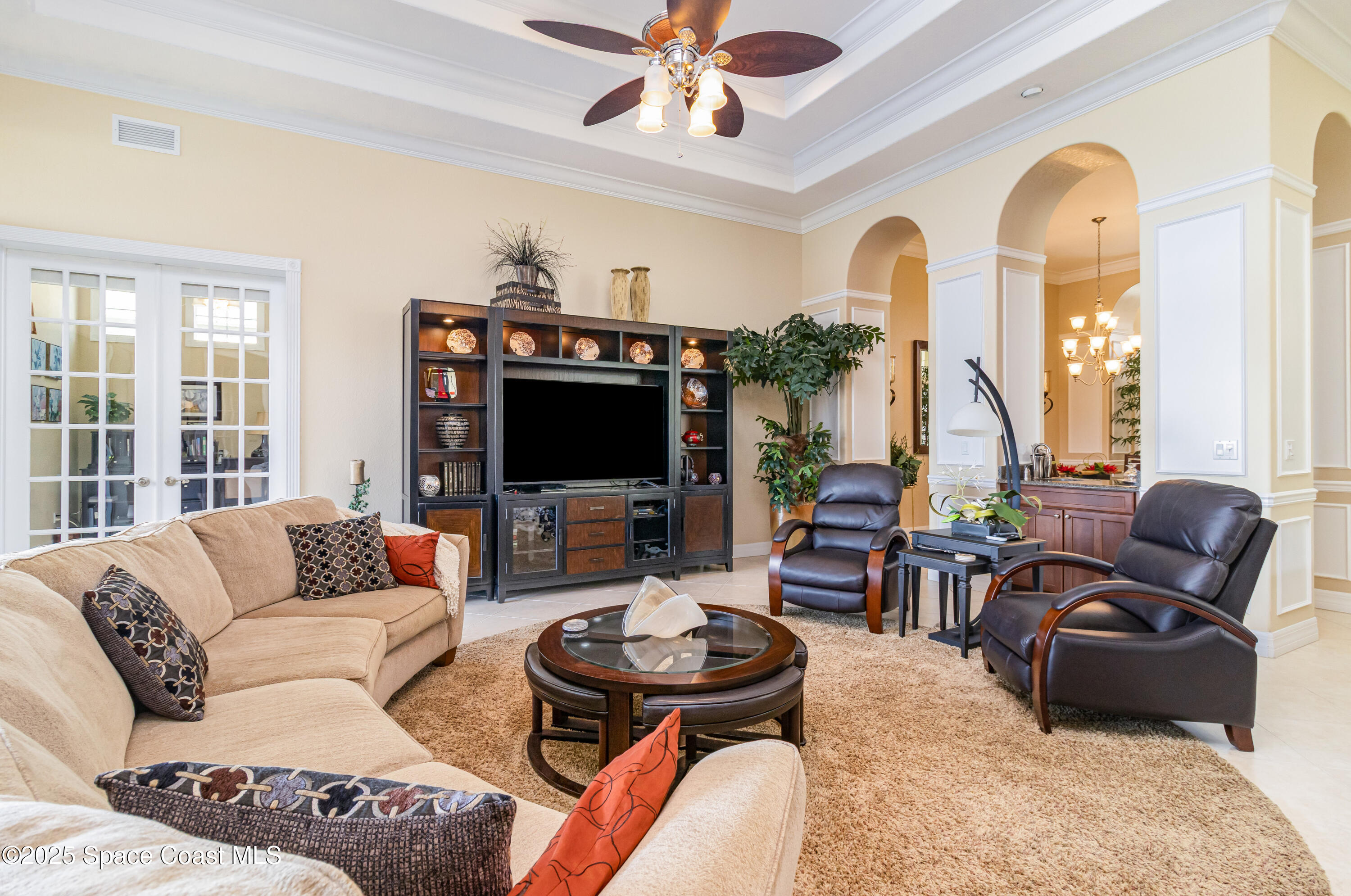 200 Harmony Lane Titusville, FL 32780 - Photo 7 of 28 a living room with furniture a flat screen tv and a large window