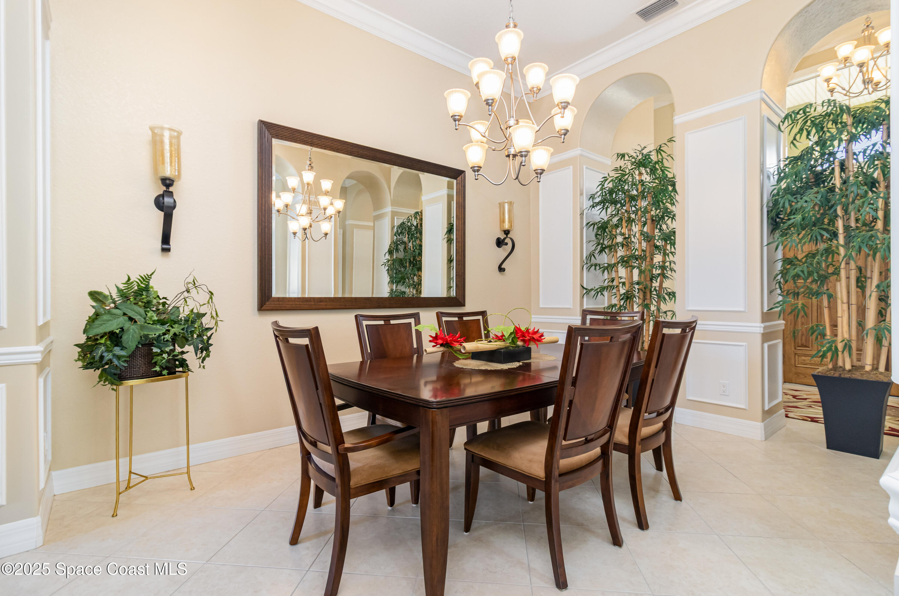 200 Harmony Lane Titusville, FL 32780 - Photo 10 of 28 a view of a dining room with furniture and a chandelier