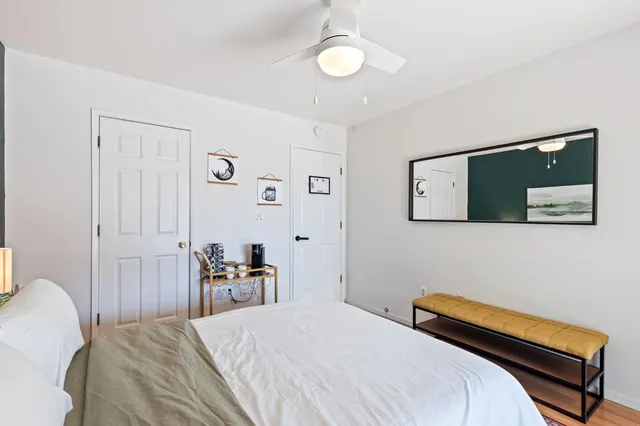 a bedroom with a bed and a chandelier