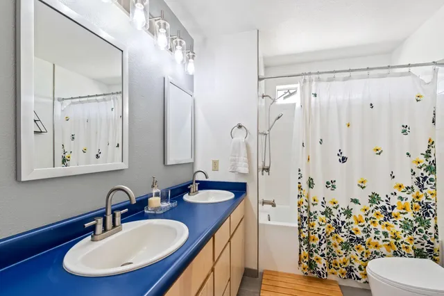 a view of a workspace with furniture and a bookshelf