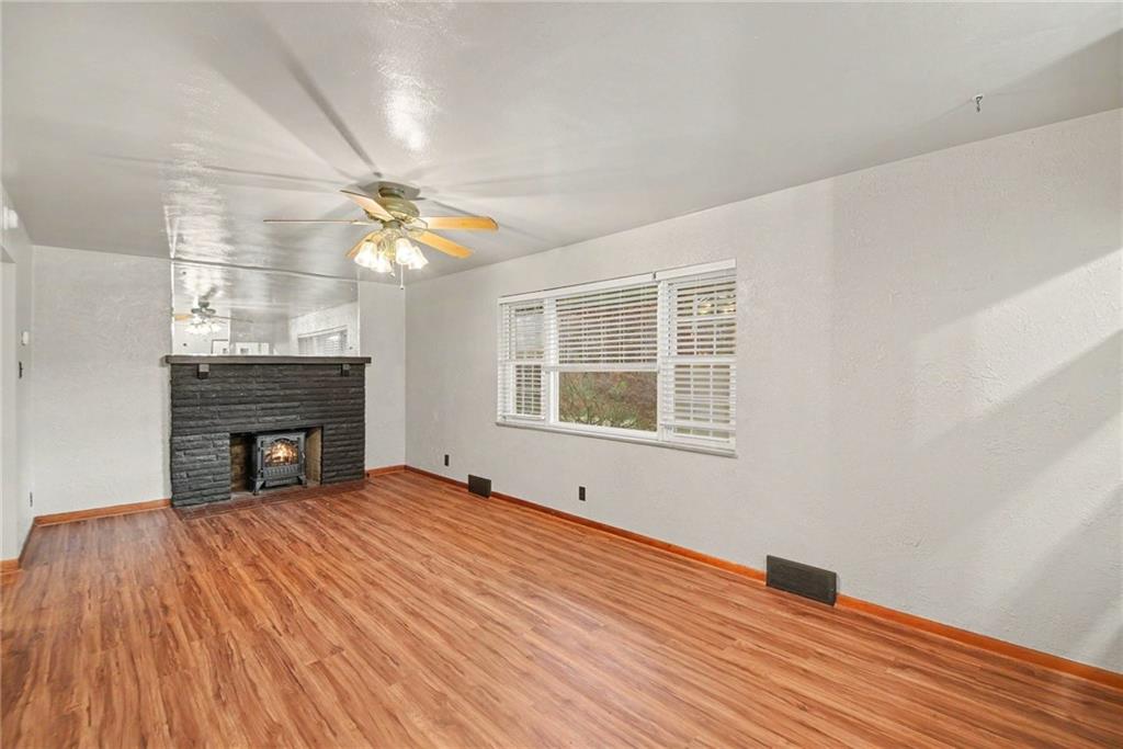 330 Butler Road Saxonburg, PA 16056 - Photo 6 of 28 a view of empty room with wooden floor and fireplace