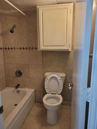 a bathroom with a sink a toilet and bathtub