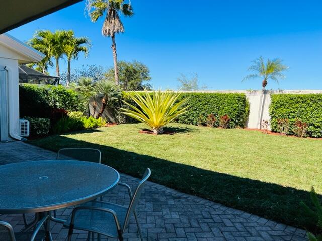 400 River Edge Road Jupiter, FL 33477 - Photo 4 of 19 a view of a chairs and table in the patio