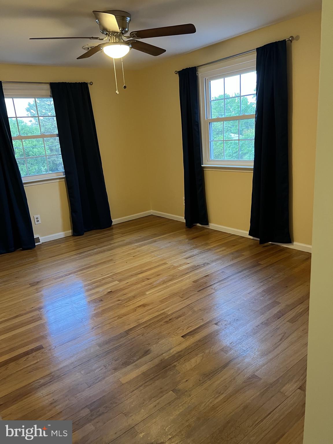 104 Cedar Street Chestertown, MD 21620 - Photo 14 of 14 an empty room with wooden floor and windows