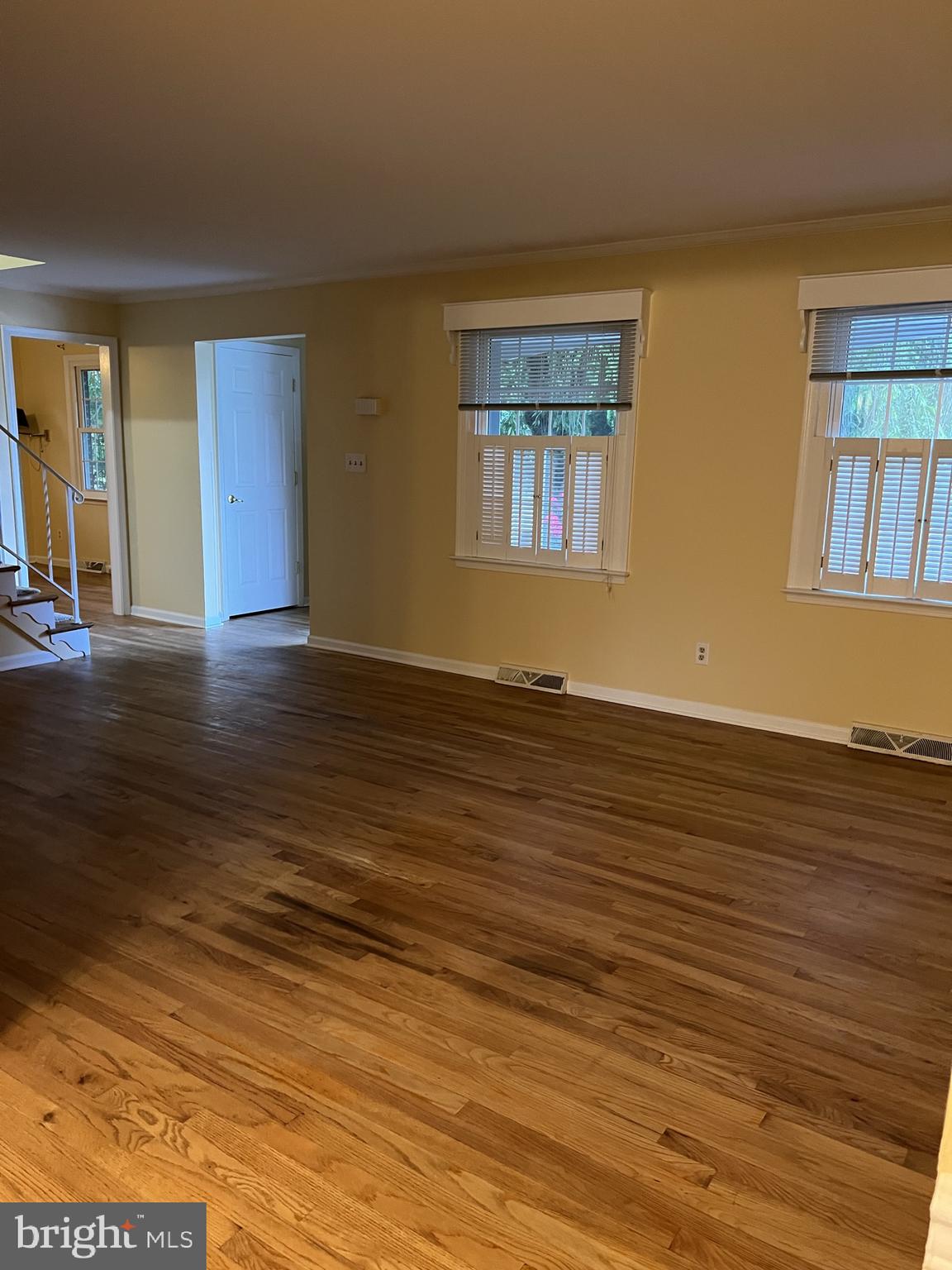 104 Cedar Street Chestertown, MD 21620 - Photo 3 of 14 a view of an empty room with wooden floor and a window