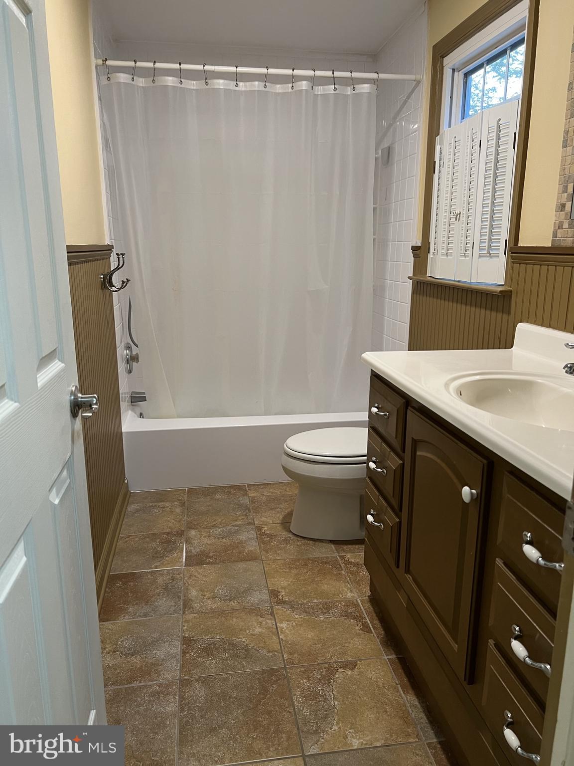 104 Cedar Street Chestertown, MD 21620 - Photo 4 of 14 a bathroom with a sink a toilet a mirror and a shower