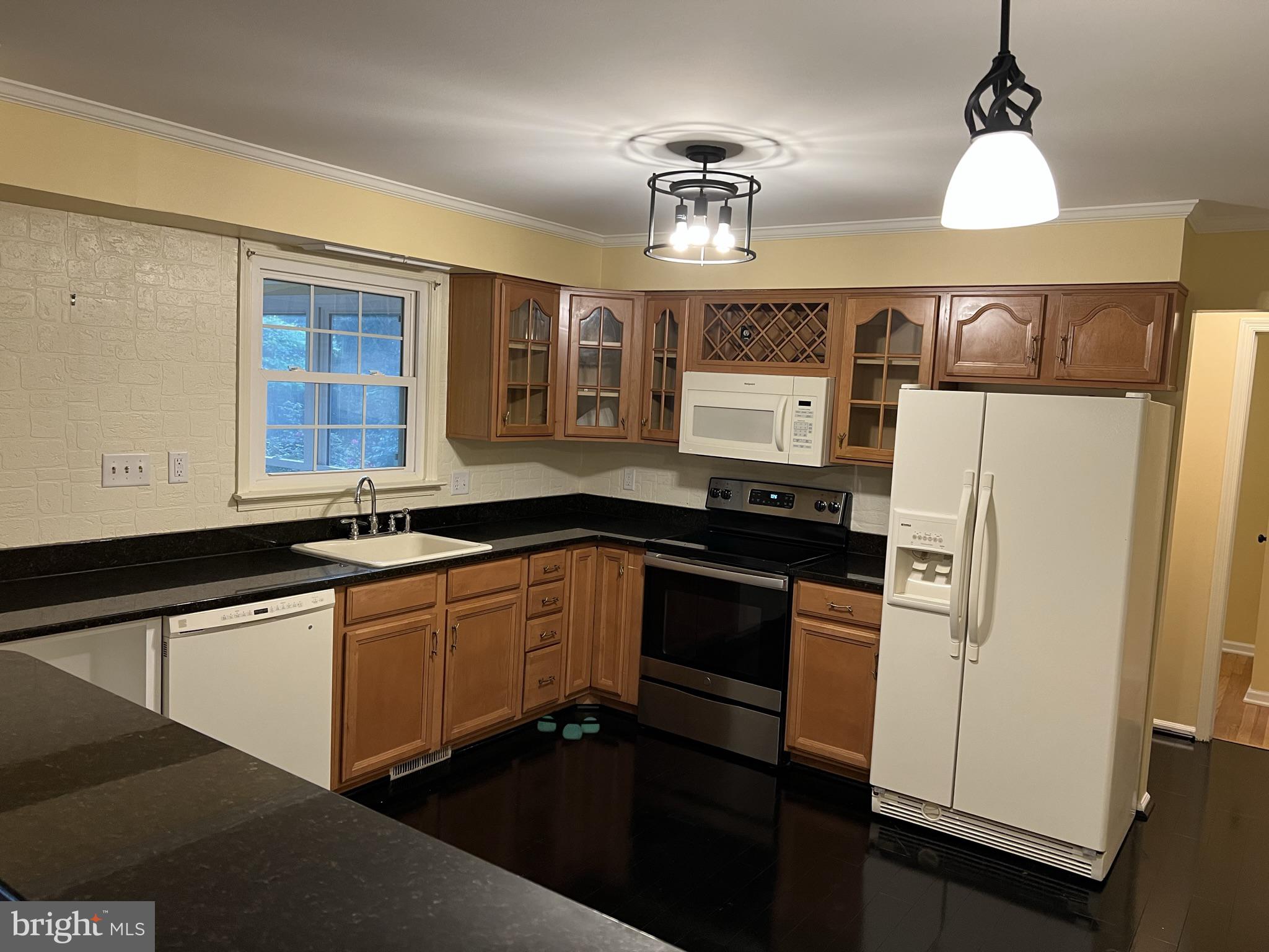 104 Cedar Street Chestertown, MD 21620 - Photo 9 of 14 a kitchen with stainless steel appliances granite countertop a sink a stove and refrigerator