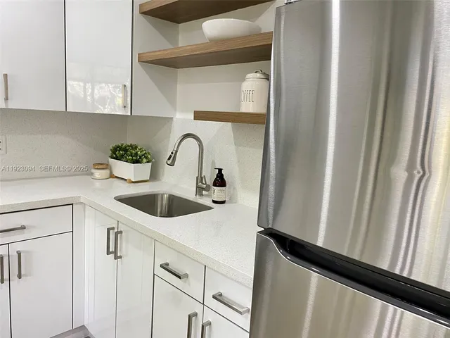 a kitchen with a sink and cabinets