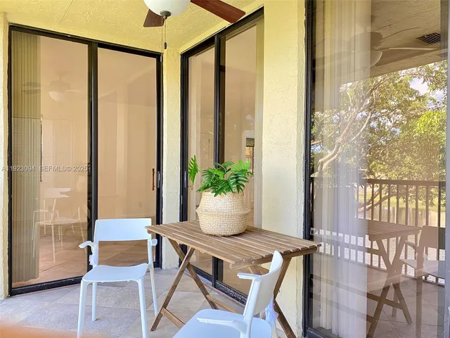 a balcony with table and chairs