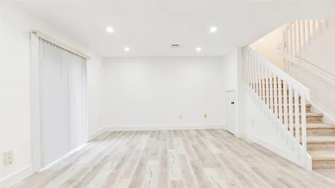 a view of hallway with wooden floor