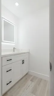 a bathroom with a sink vanity and mirror