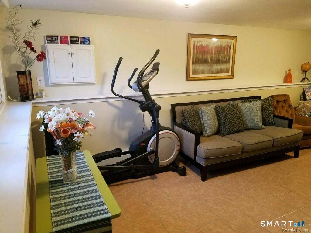 54 Berkshire Road West Hartford, CT 06107 - Photo 17 of 26 The cozy family room on the lower level is the perfect place for movie night with the family.