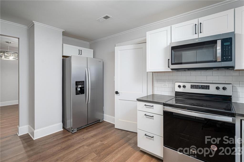 2496 Shoal Road Crouse, NC 28033 - Photo 11 of 29 a kitchen with cabinets stainless steel appliances and wooden floor