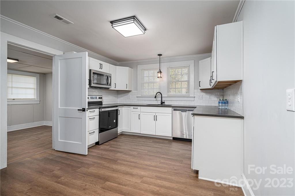 2496 Shoal Road Crouse, NC 28033 - Photo 12 of 29 a kitchen with granite countertop white cabinets and white appliances