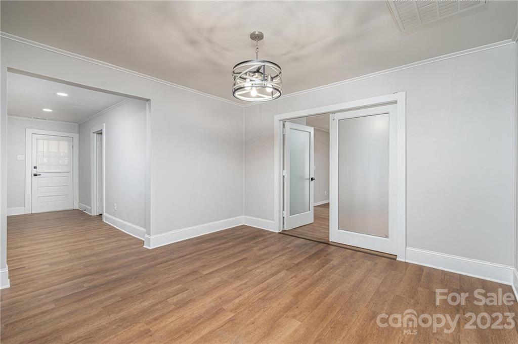 2496 Shoal Road Crouse, NC 28033 - Photo 13 of 29 an empty room with wooden floor cabinet and ceiling fan