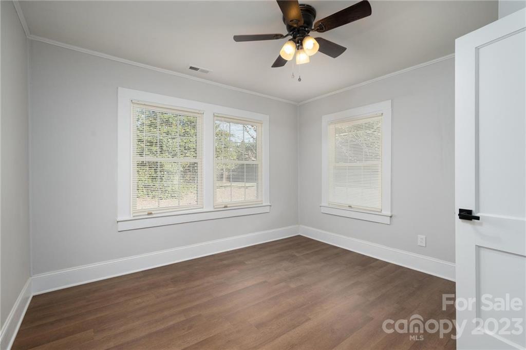 2496 Shoal Road Crouse, NC 28033 - Photo 20 of 29 an empty room with wooden floor fan and windows
