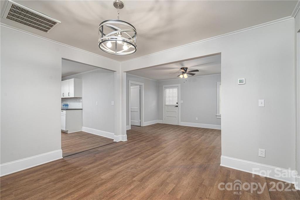 2496 Shoal Road Crouse, NC 28033 - Photo 7 of 29 an empty room with wooden floor and windows