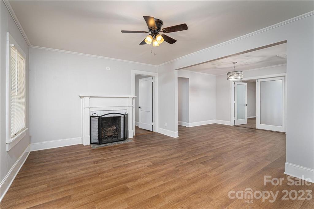 2496 Shoal Road Crouse, NC 28033 - Photo 9 of 29 a view of an empty room with wooden floor a fireplace and a window