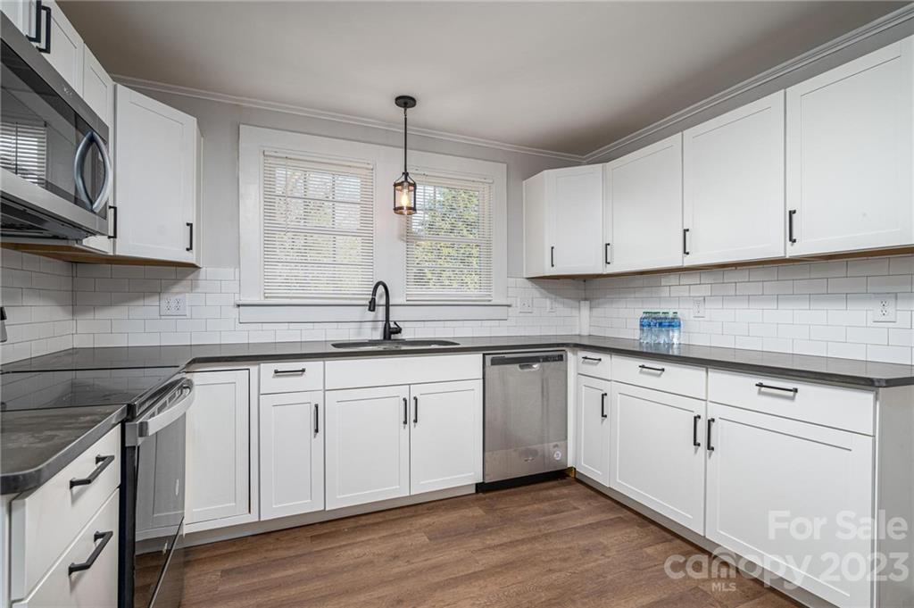 2496 Shoal Road Crouse, NC 28033 - Photo 10 of 29 a kitchen with granite countertop white cabinets white appliances and sink