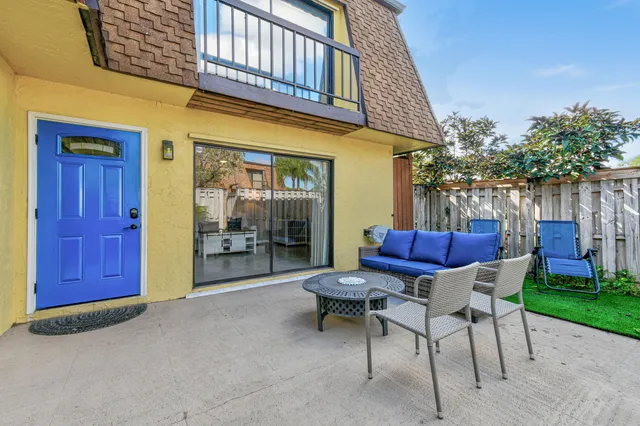 a view of a house with backyard and sitting area