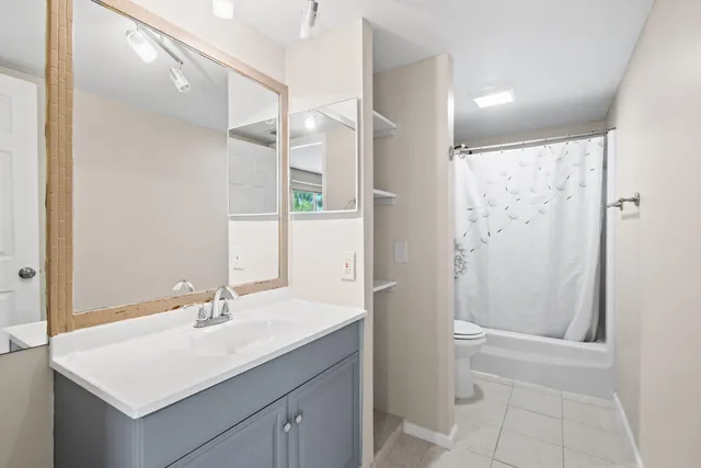 a bathroom with a shower a toilet and a shower