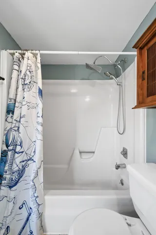 a view of walk in closet with clothes