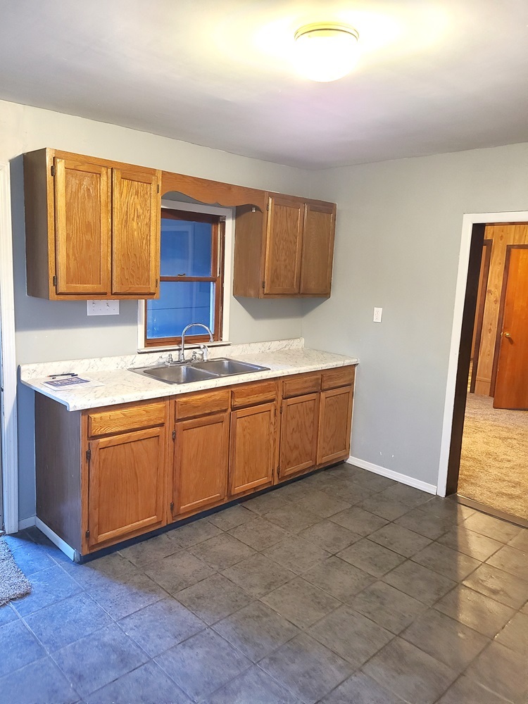 902 West 5th Street Sterling, IL 61081 - Photo 4 of 20 a kitchen with stainless steel appliances granite countertop a sink and cabinets